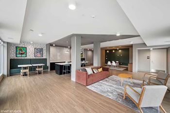 a living room with a couch and chairs and a table